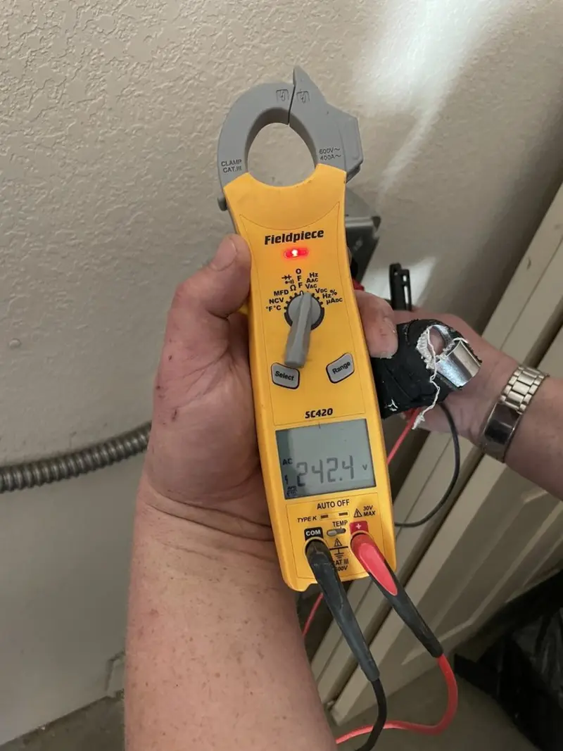 Voltage testing with clamp meter during Recessed Lighting Installation in Newnan